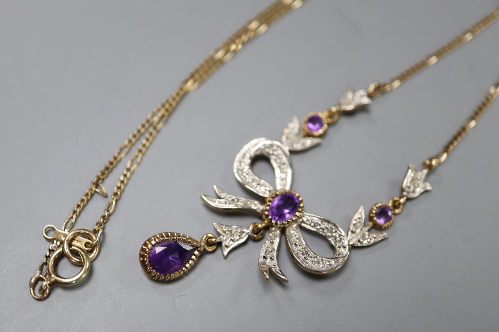 An amethyst-set tied ribbon pendant with drop on 9ct gold fine chain, 40cm, gross 4.1 grams.